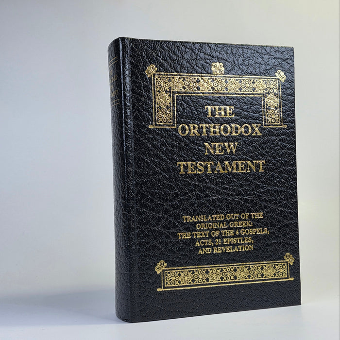 Black leather-bound book titled 'The Orthodox New Testament' on a white background