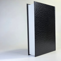 Black leather-bound book on a white background